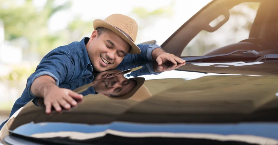 Vemos uma pessoa feliz em contar com a associação de proteção veicular.